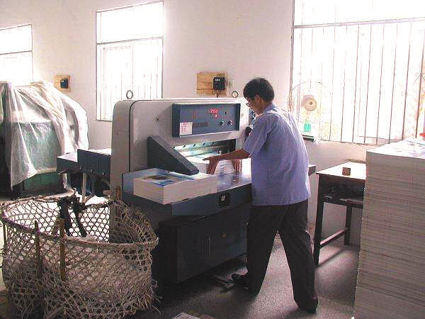 Workers Trimming Paper