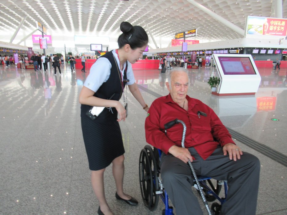 Airline Employee Wheels Paul to Airport Exit  