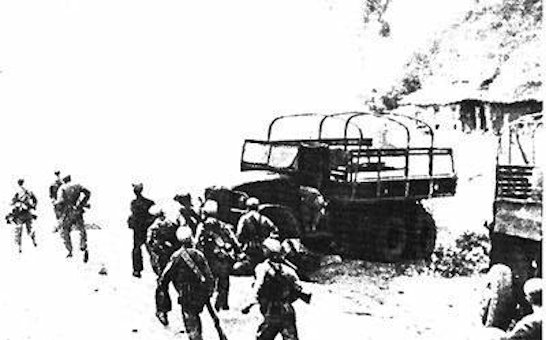 The Chinese Troops Rush past Abandoned USA Trucks  in the Chosin Reservoir