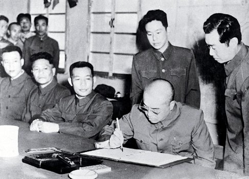 General Peng Dehuai signs the Armistice